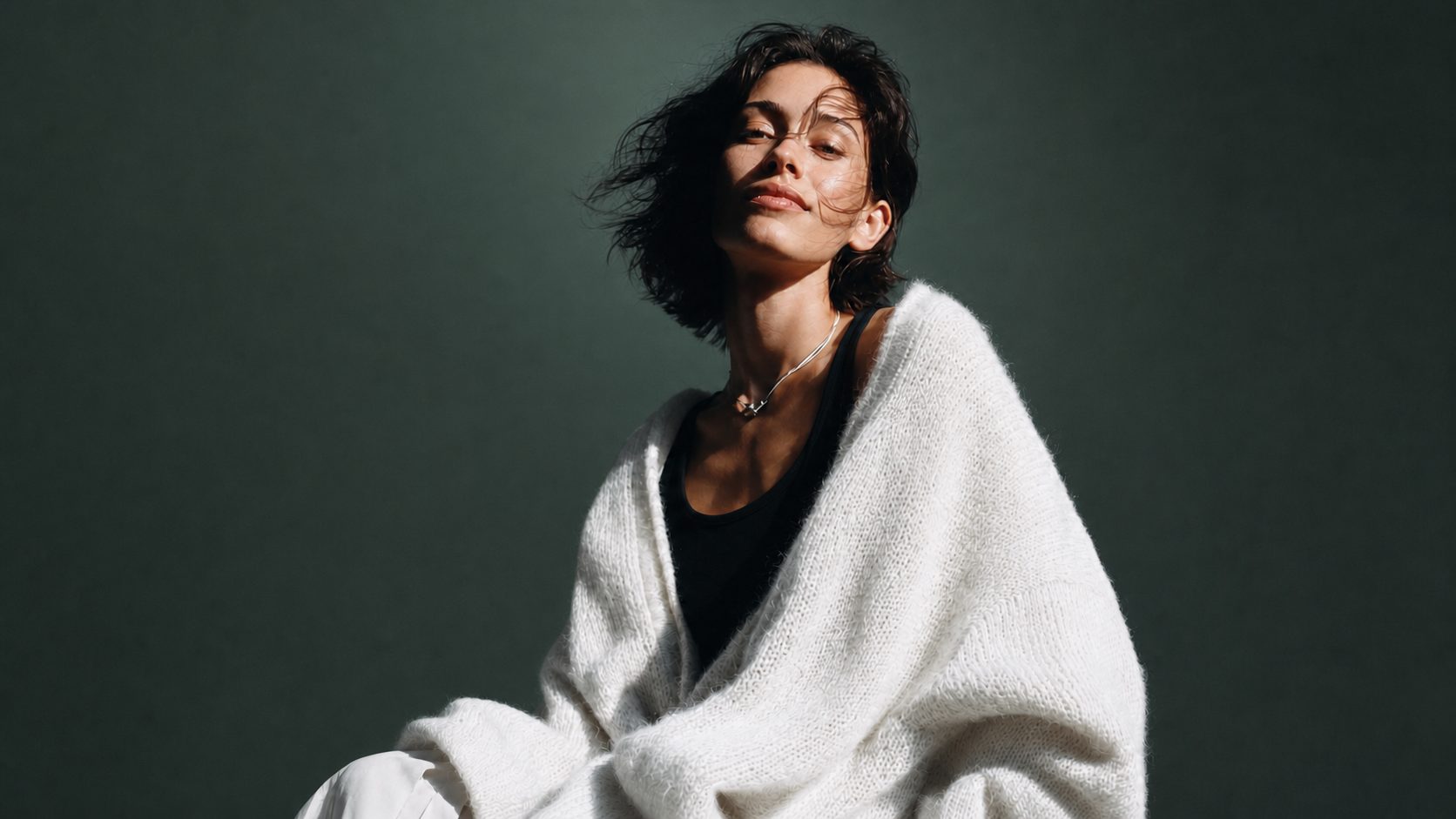 A woman seated in warm directional light